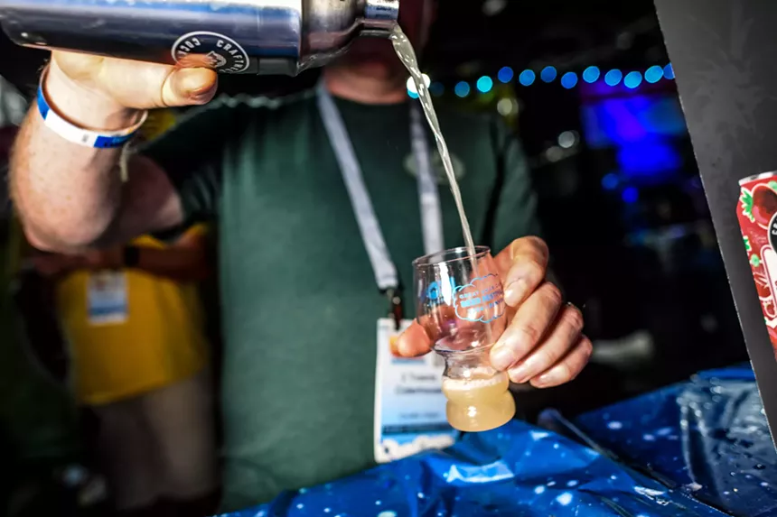 beer being poured into a small glass