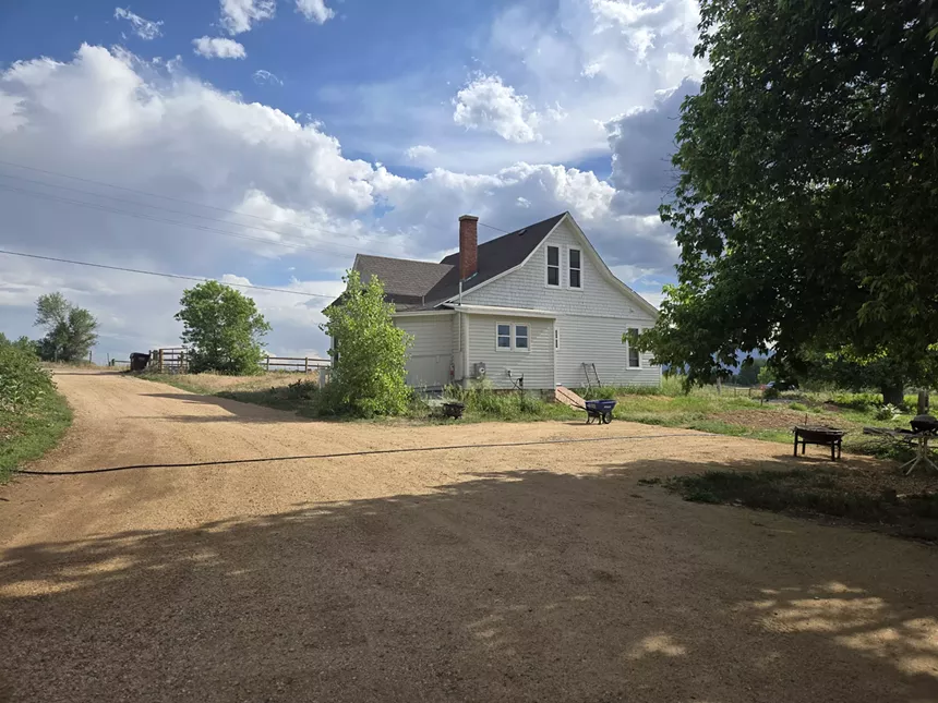 an old white house on a farm