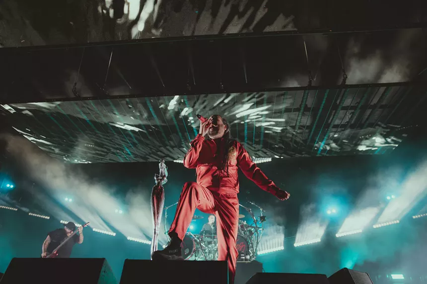 a man standing on top of a stage in front of a crowd