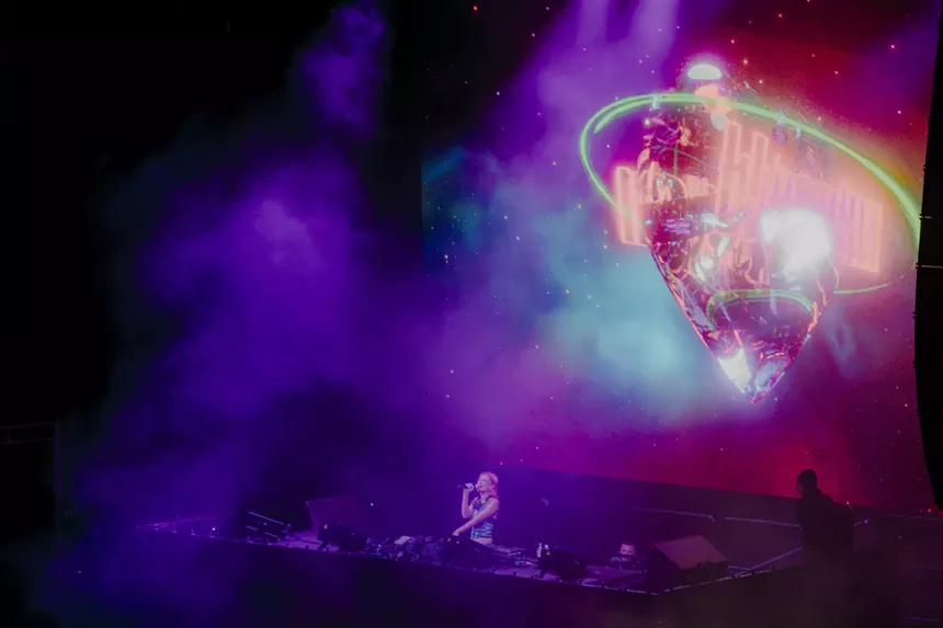 A photo showing the DJ called Blossom performing on a large stage at Red Rocks.