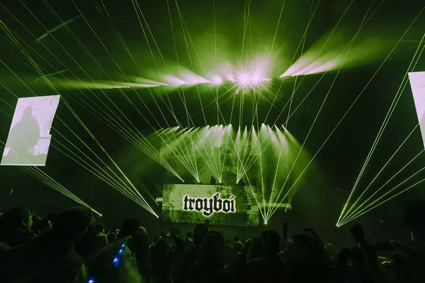 A photo showing the production lights and lasers during Troyboi's set at Red Rocks.