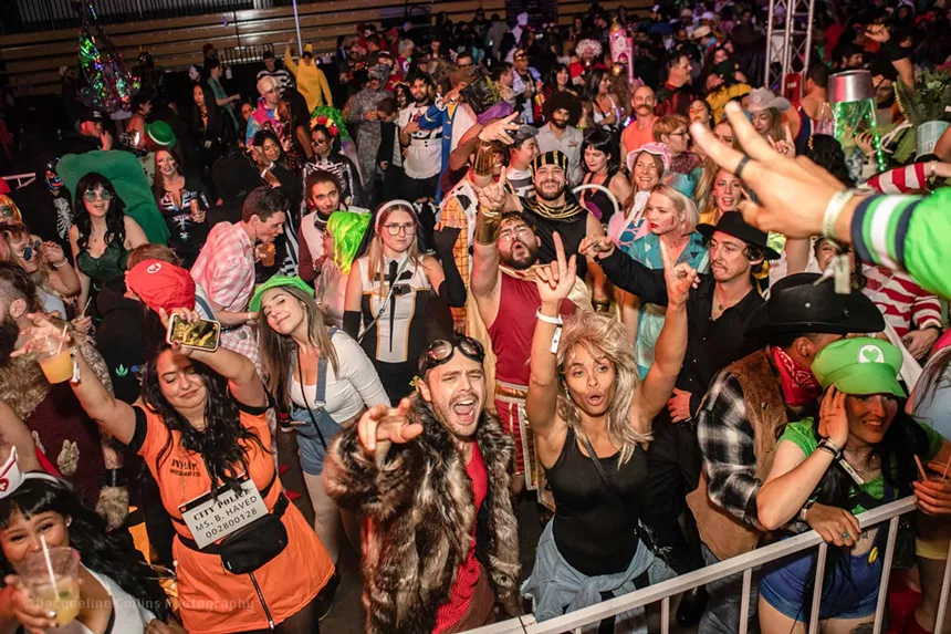 Halloween rave crowd dancing and smiling