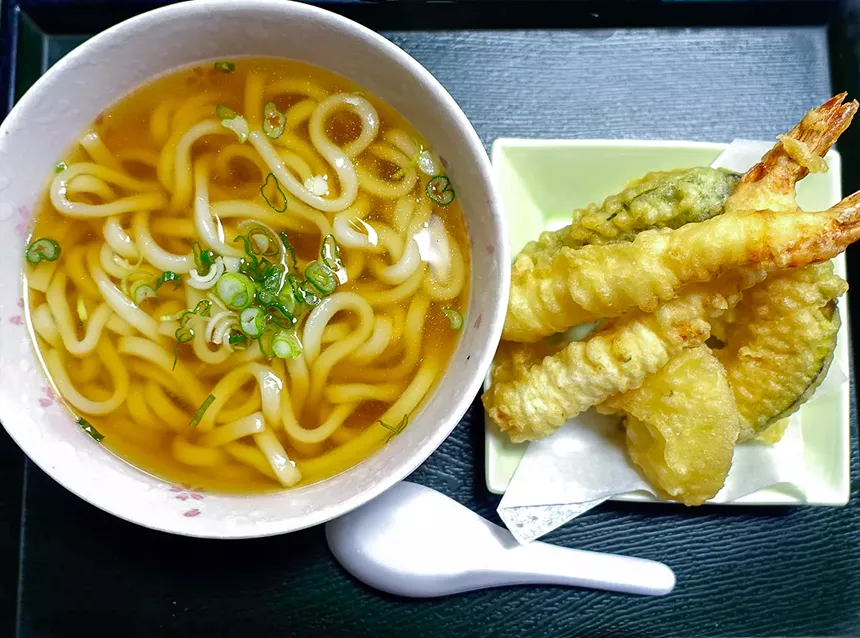 bowl of noodles in broth and tempura veggie and shrimp