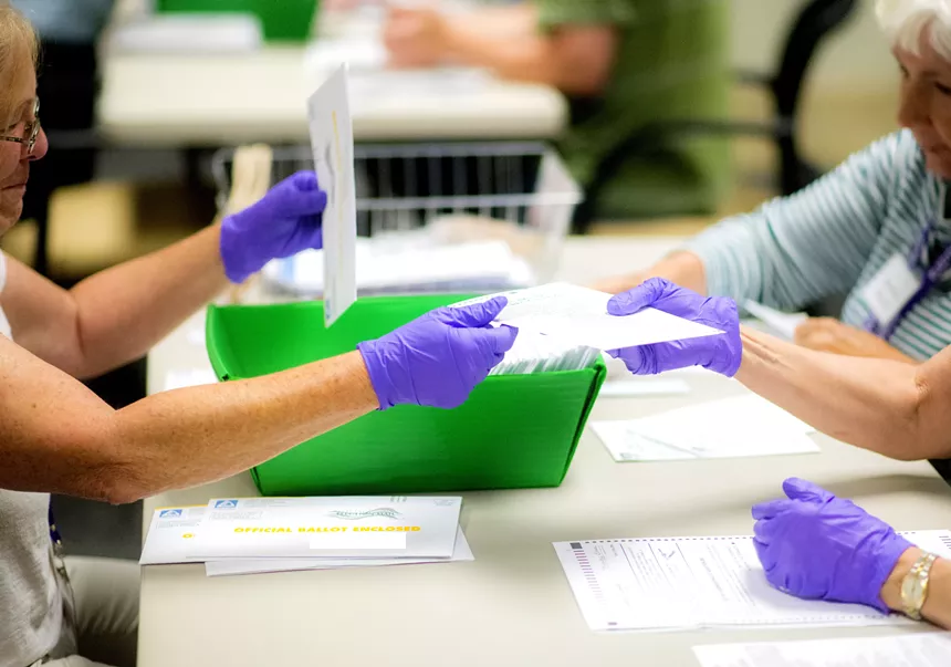 election workers in gloves