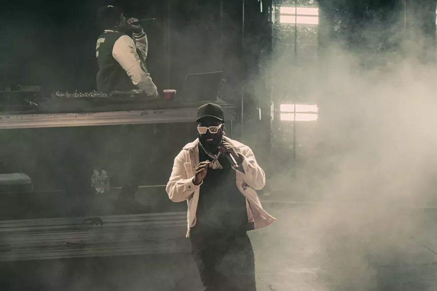 A photo of T-Pain on stage performing at Red Rocks in Morrison, Colorado.