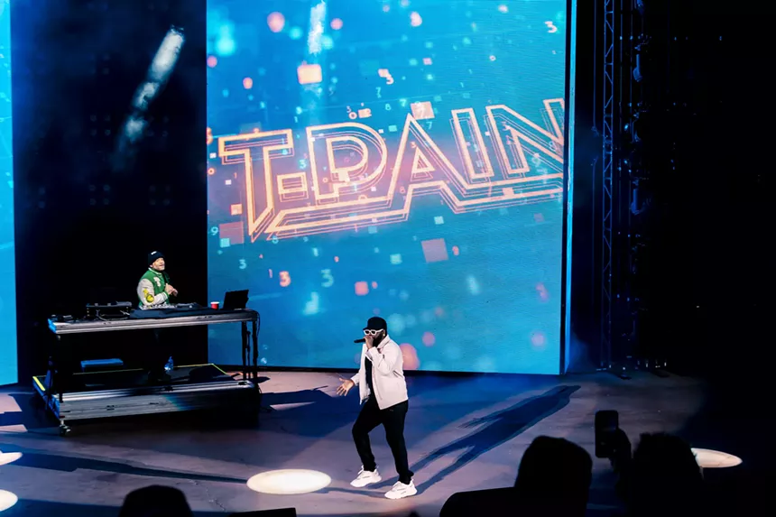 A photo of T-Pain on stage performing at Red Rocks in Morrison, Colorado.
