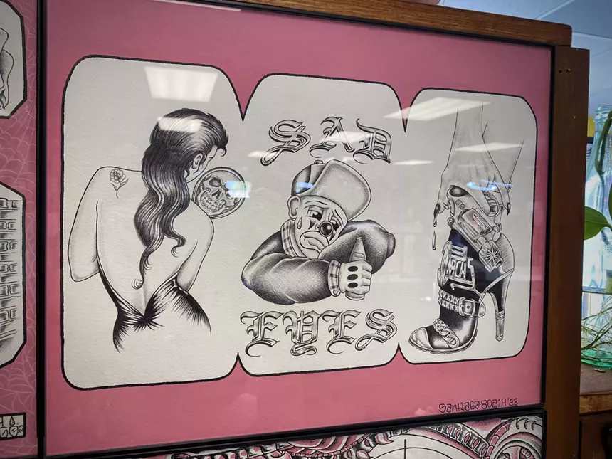 A shot of tattoo flash hanging on the wall at Skull and Dagger Tattoo Co.
