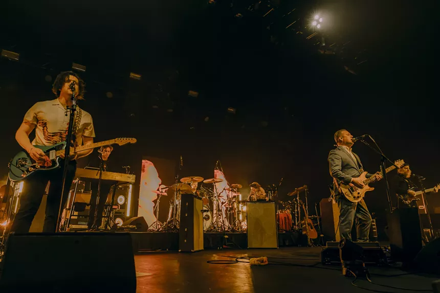 A wide shot of Modest Mouse on stage.
