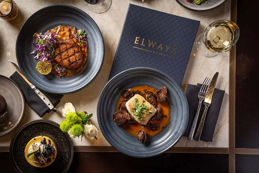 Elway's navy-colored menu and various dishes featuring a filet, Brussels sprouts and more