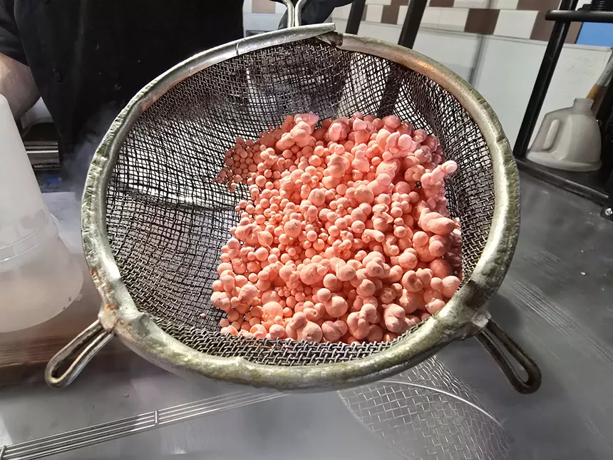 liquid nitrogen dot ice cream in a strainer