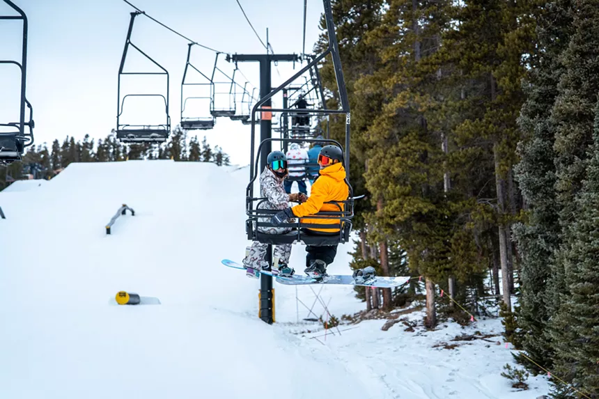 Snowboarders on a ski lift at Eldora Resort