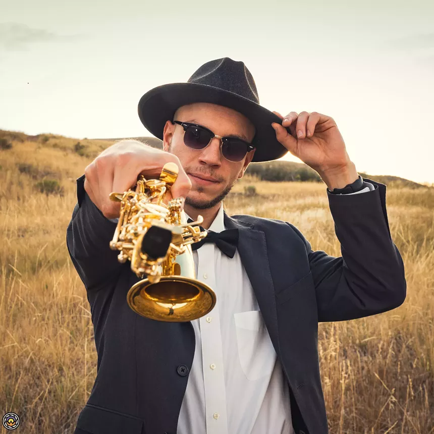 man pointing saxophone at camera