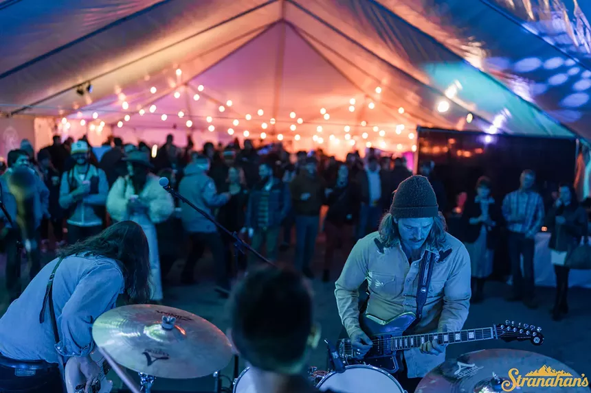 people under a tent with lights