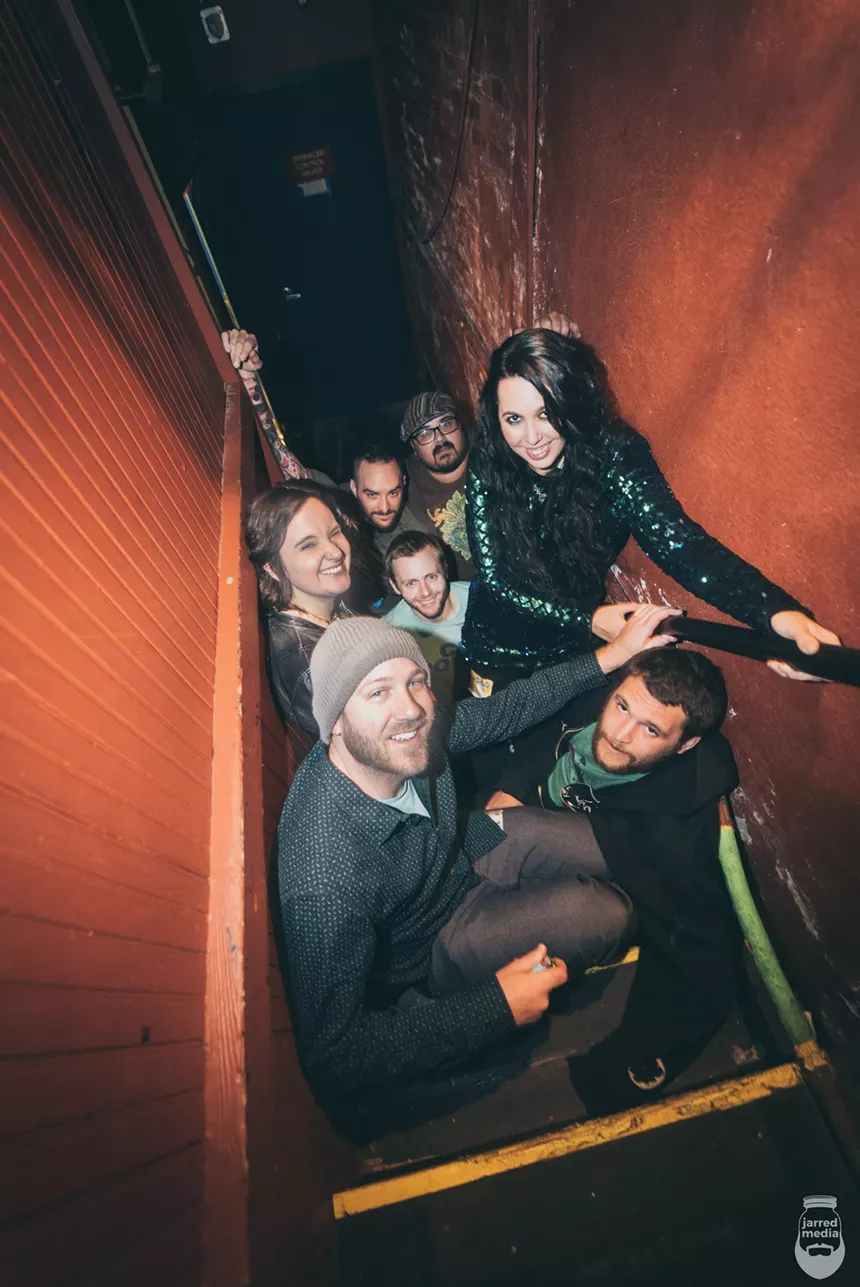 The members of the band Tnertle standing in a stairwell.