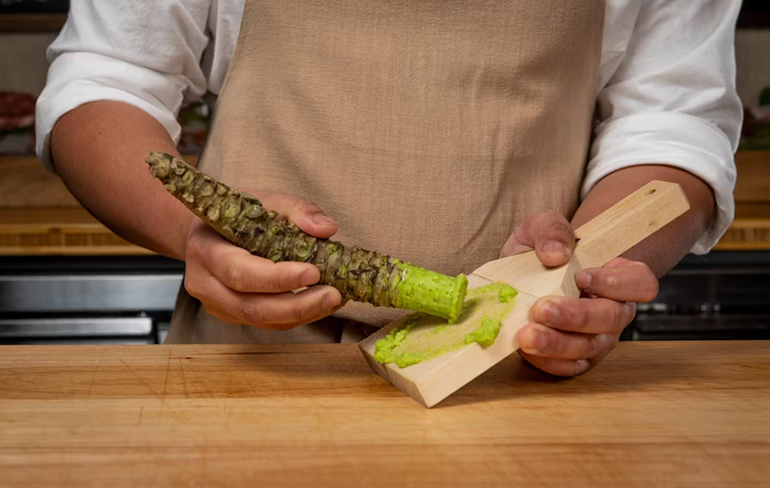 person grating wasabi root