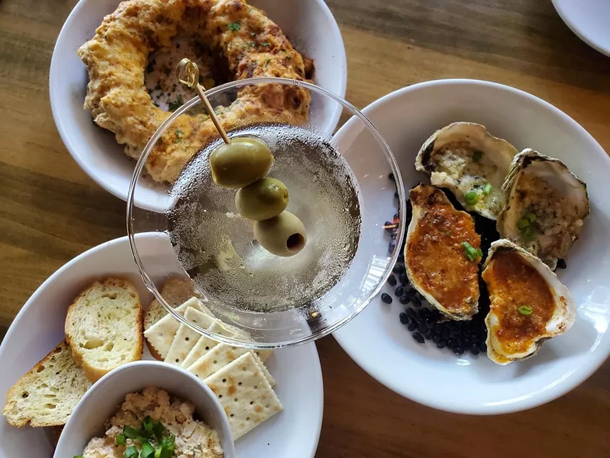 a martini surrounded by various dishes