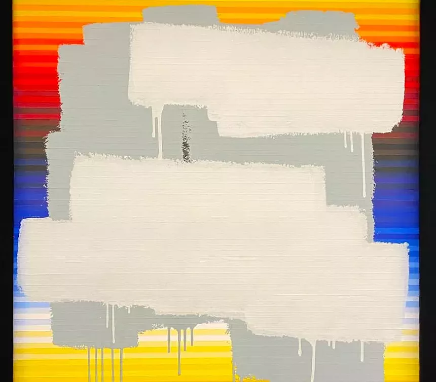 White paint covers a vibrant canvas of color.