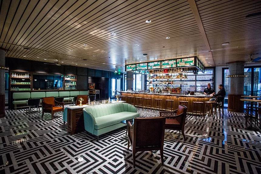 interior of a bar with teal couches