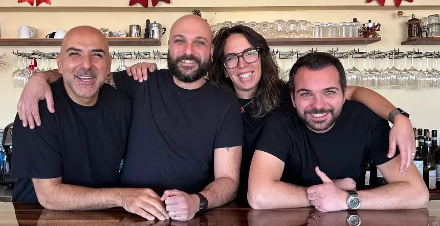 four people in black t shirts