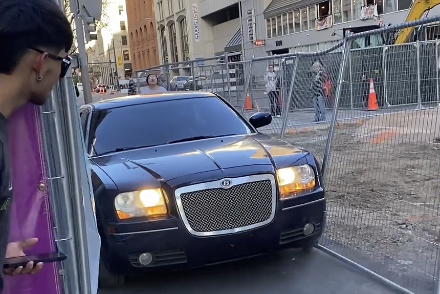 Black Chrysler 300 with fake Bently sign drives through fence