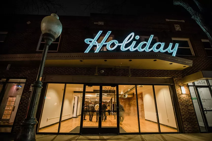 a building with a sign that says Holiday Theater