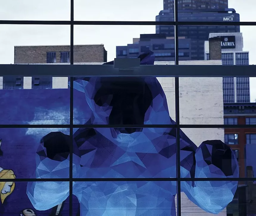 blg blue bear looking in window.