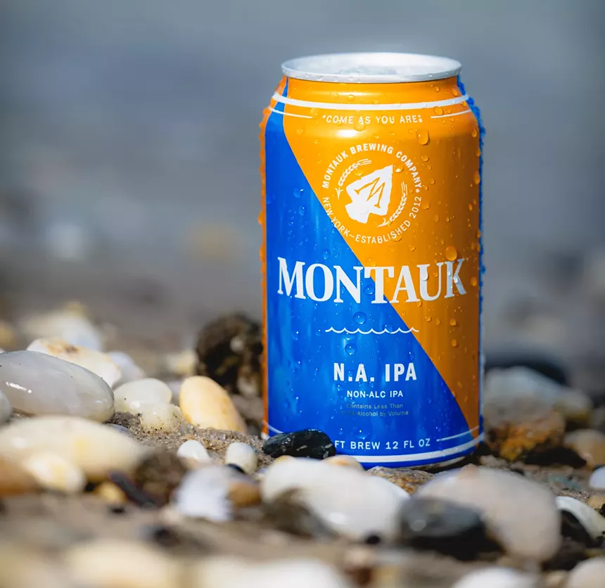 Can of beer on the beach.