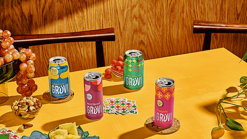 Four non alcoholic beers with cards on a table.