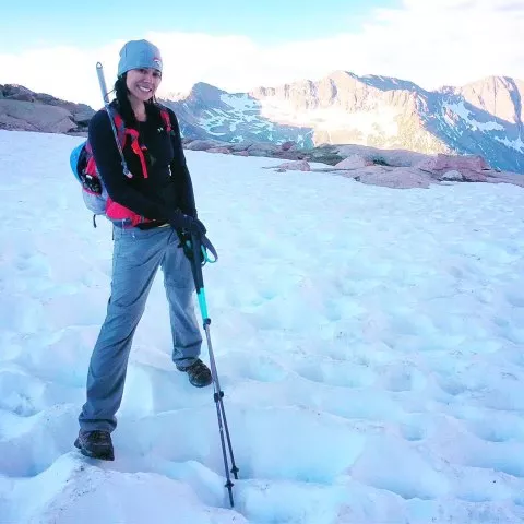 Woman stands on snowy mountain
