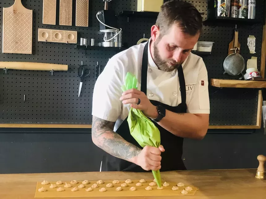 chef piping ravioli filling