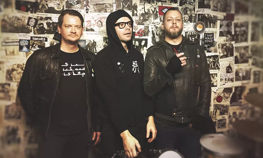 The three original members of Palehorse/Palerider standing against a wall