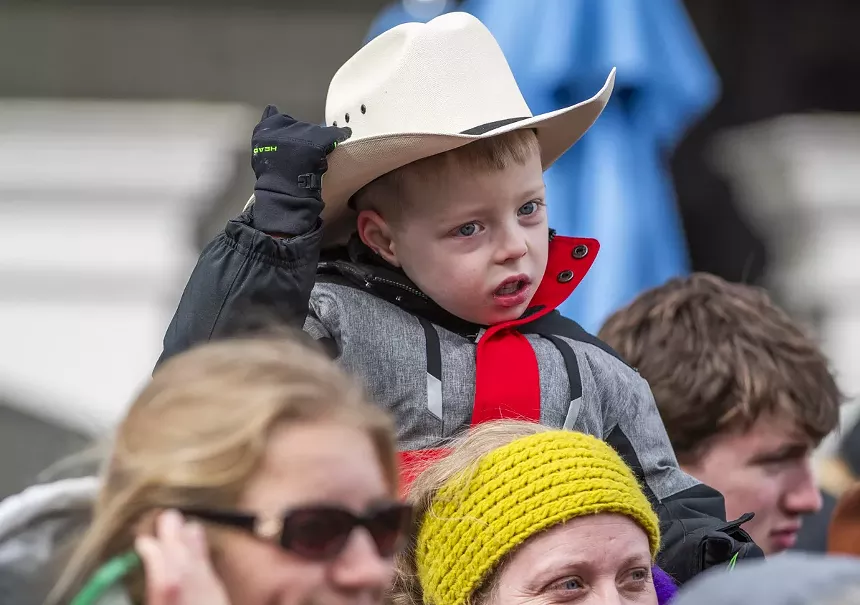 kid in cowboy hat at parade