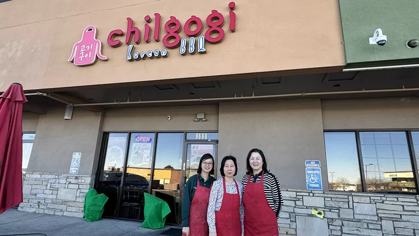 three women posting in front of a restaurant