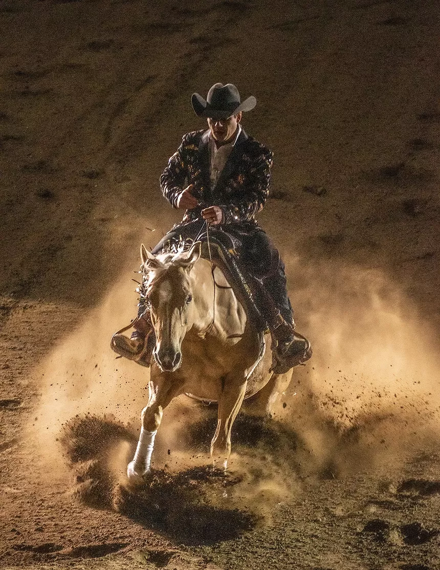 cowboy sliding in on horse