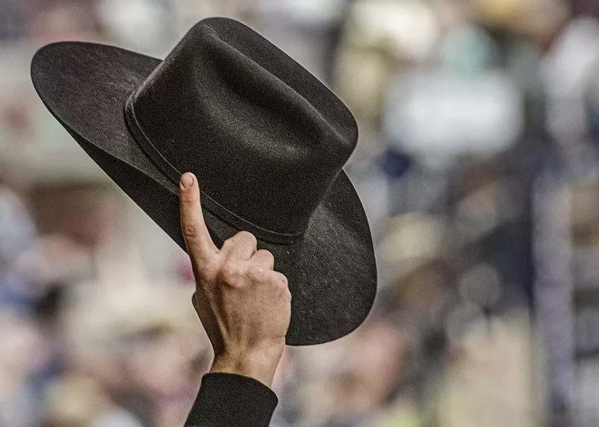 hand holding cowboy hat.
