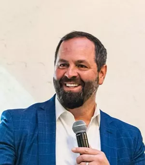 man in blue jacket with mic