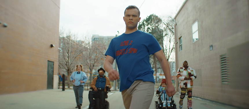 A group of people walk defiantly.