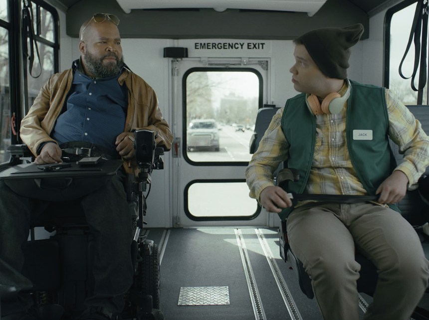 Two people sit on a bus.