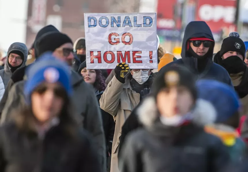 protester holding anti-trump sign