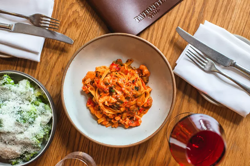 A leafly salad and tomato-based pasta dish from Tavernetta Vail