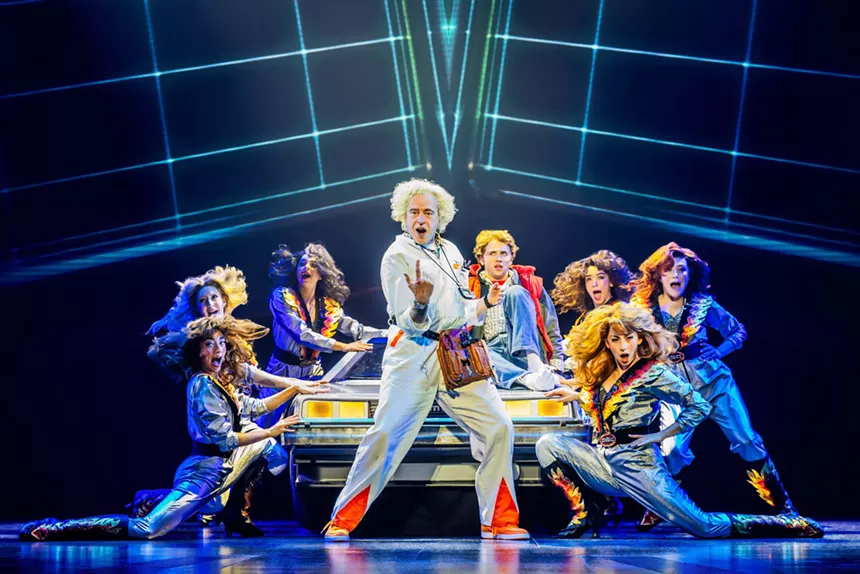 Doc Brown with a chorus of dancers