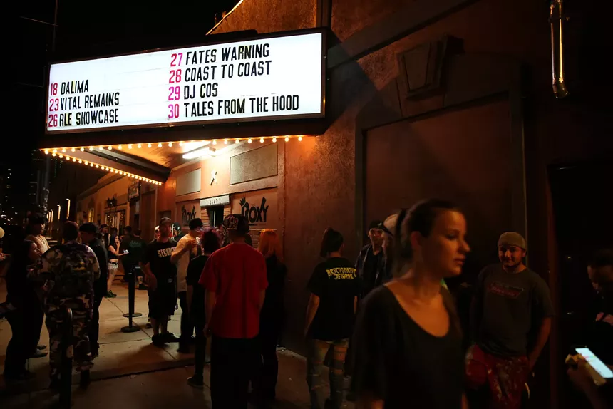 Patrons outside the Roxy Theatre with marquee in the background.