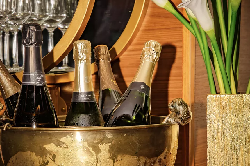 Champagne bottles in a golden ice bucket at Champagne Tiger