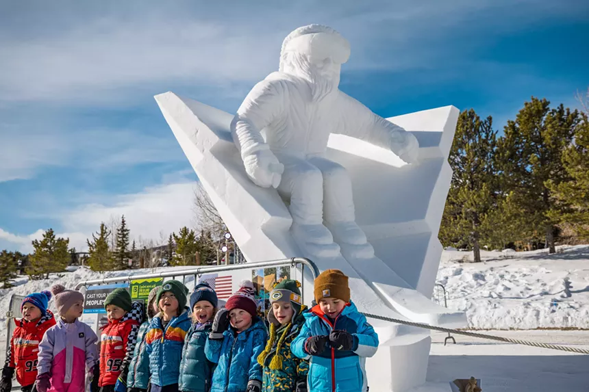 kids in front of snow sculpture