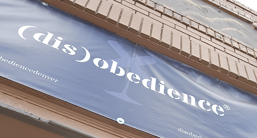 A store banner reading "(dis)obedience"