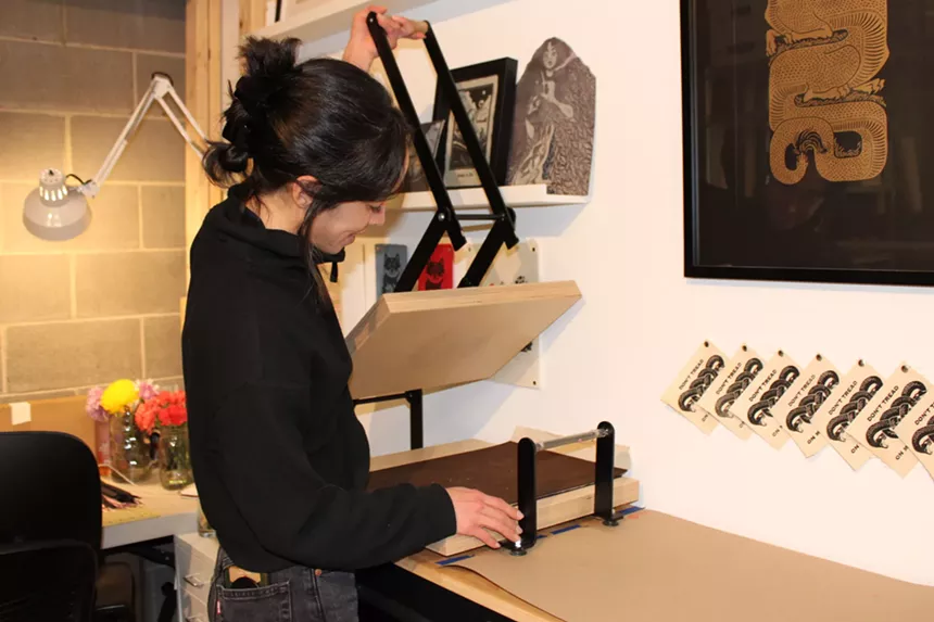 A woman works in an art studio at RedLine.