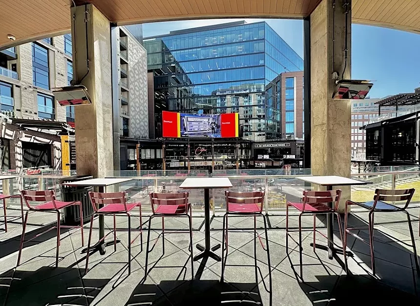 bar stools overlooking a large LED screen