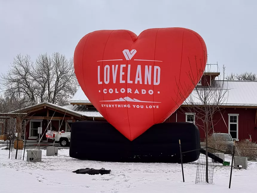 A big red heart bearing Loveland's logo