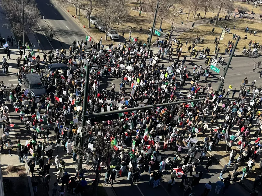 Protesters rally at an intersection.