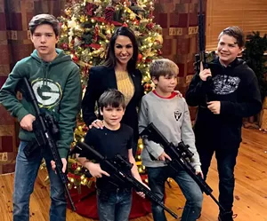 woman and chlidren with guns